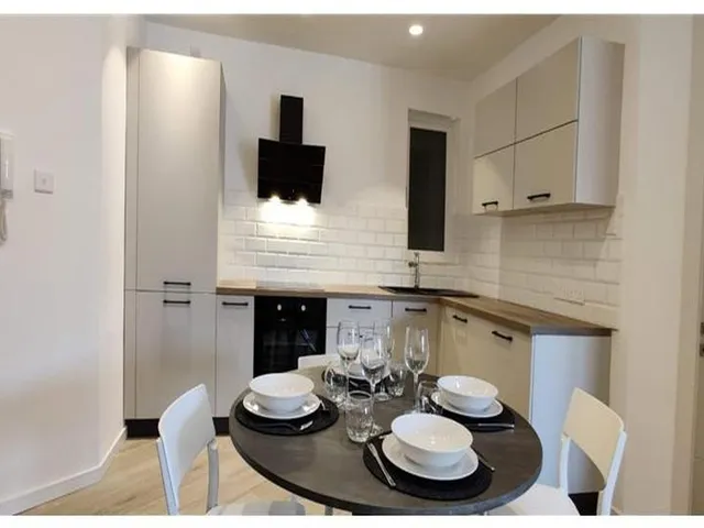 a kitchen with a white table and a white counter top