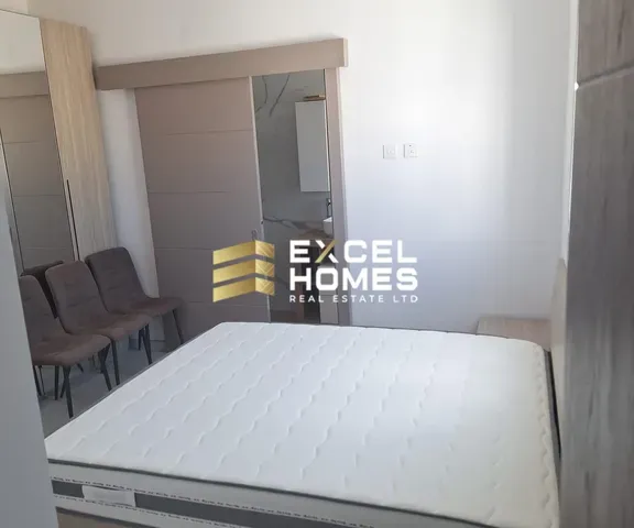 a white chair sitting in a room with a white wall