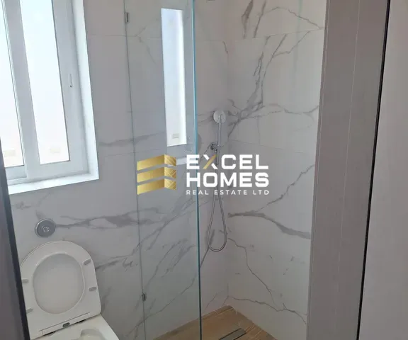 a bathroom with a toilet and a shower stall