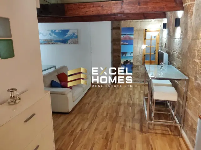 a kitchen with a table and a chair
