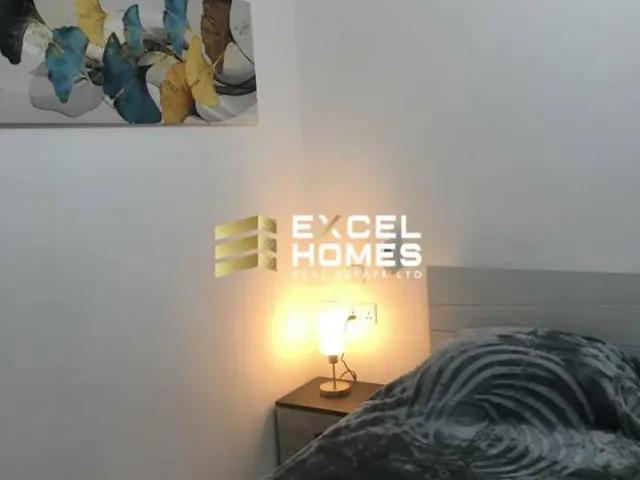 a lamp is lit up in a room with a bed