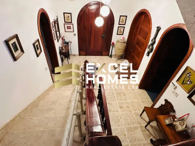 a room with a lot of chairs and a lot of pictures on the wall
