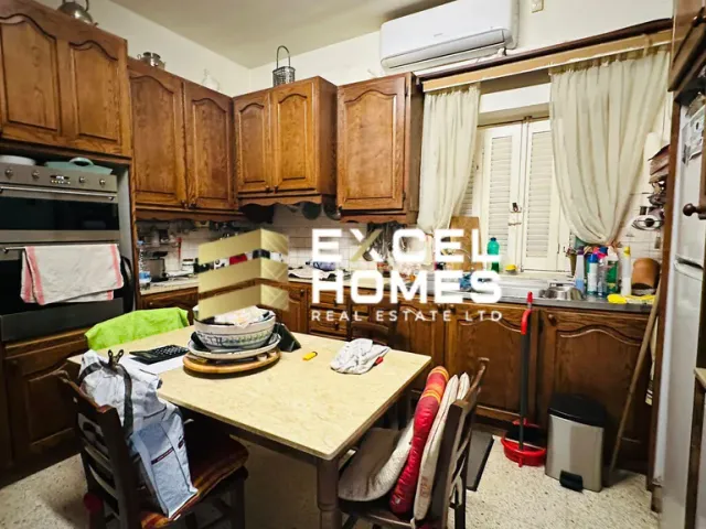 a kitchen with a stove, sink, and refrigerator