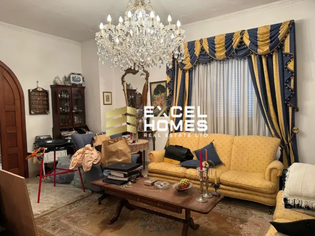 a living room with a couch, chair, and a lamp
