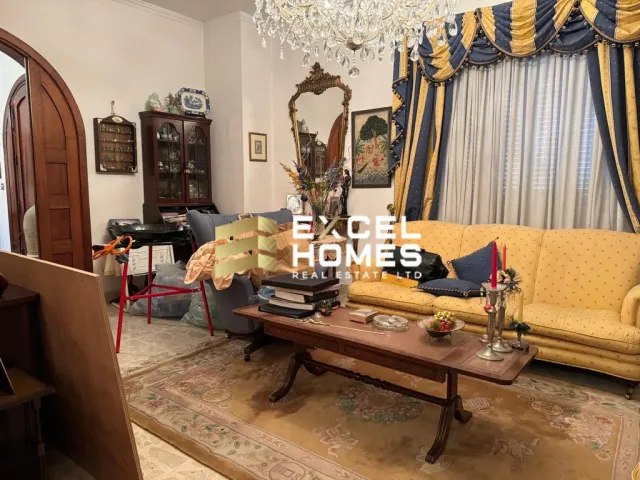 a living room with a couch, coffee table, and a lamp