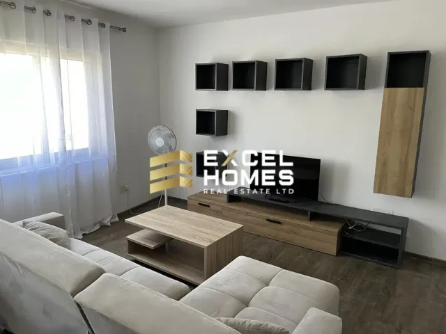 a living room with a couch, chair, and television