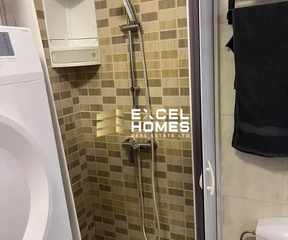 a bathroom with a toilet and a shower stall