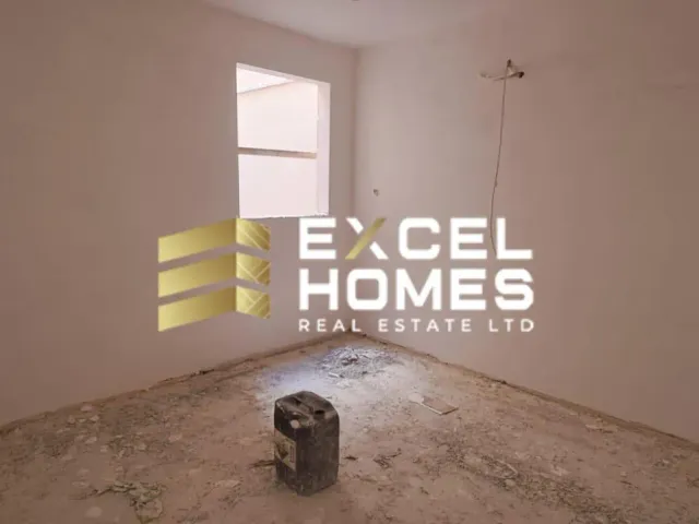 a dirty bathroom with a broken wall and a broken window