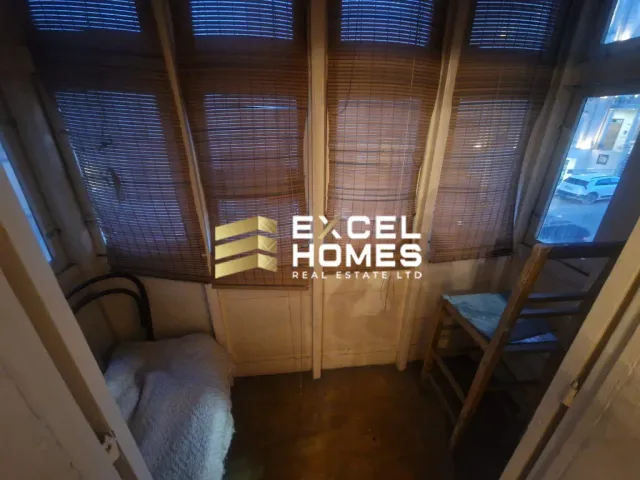 a room with a window and a toilet