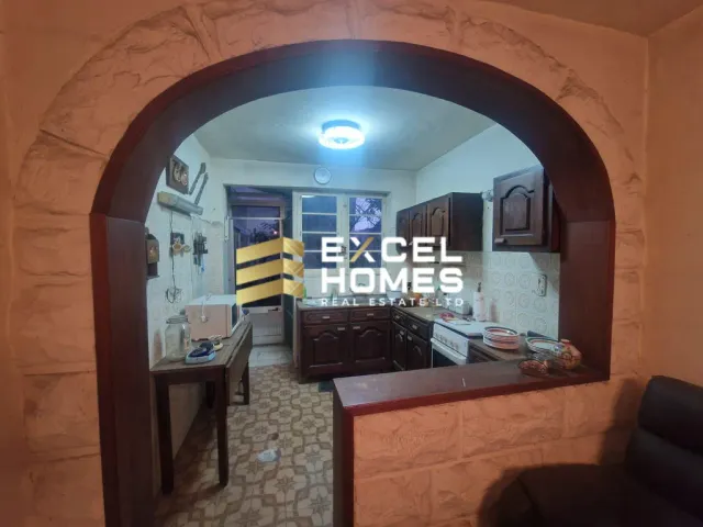 a kitchen with a large window and a large mirror