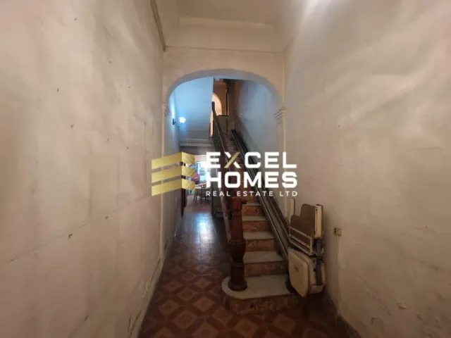 a man standing in a doorway with a surfboard