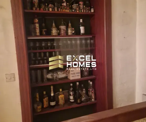 a shelf with bottles of wine and bottles of beer