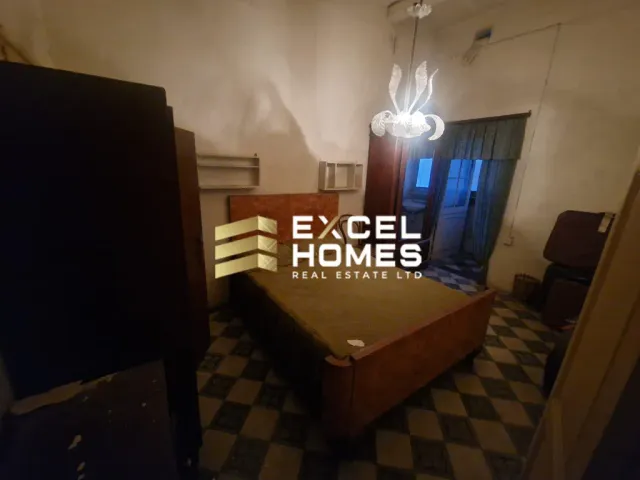 a bedroom with a bed and a lamp