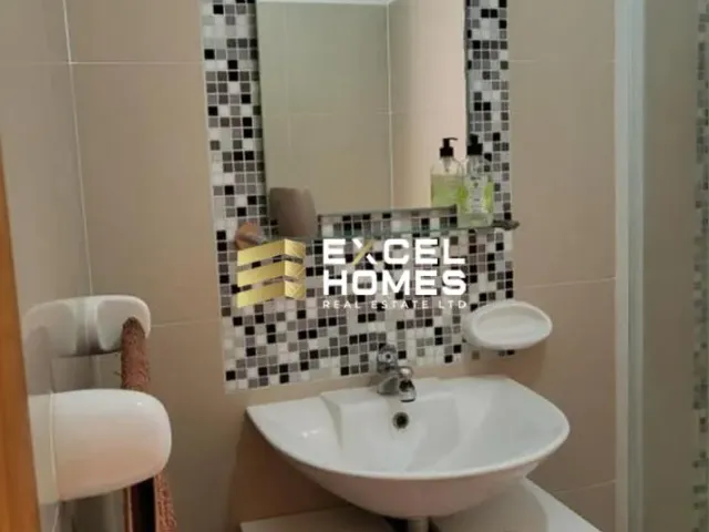 a bathroom with a sink, mirror, and a bath tub