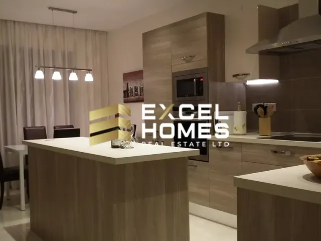 a kitchen with a large white refrigerator and a large window