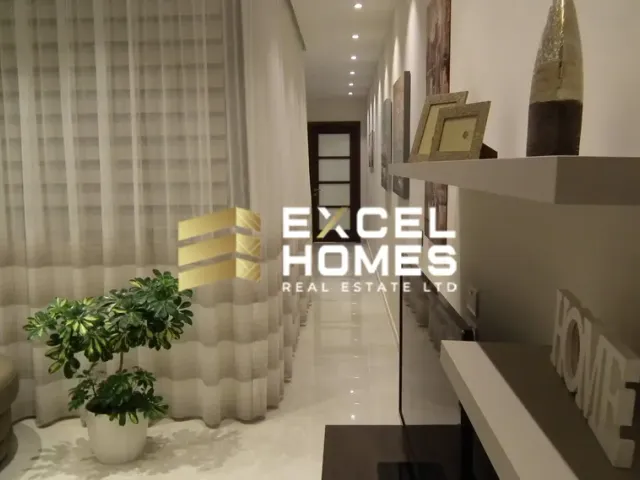 a living room with a large window and a large table