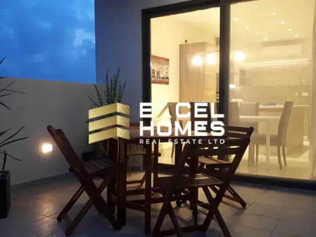 a dining room table with a lamp and a window