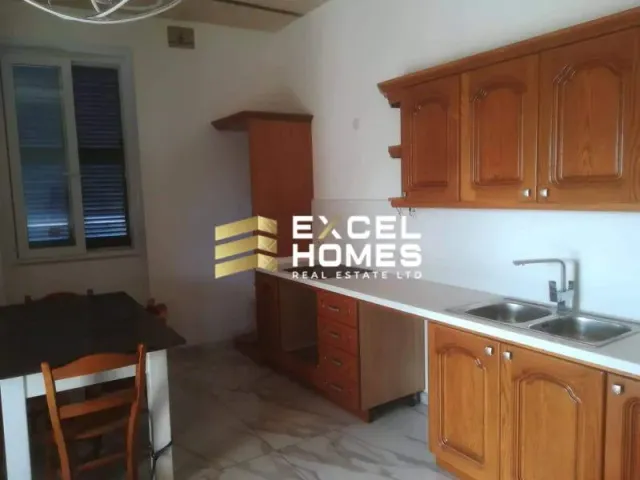 a kitchen with a sink, stove, and a refrigerator