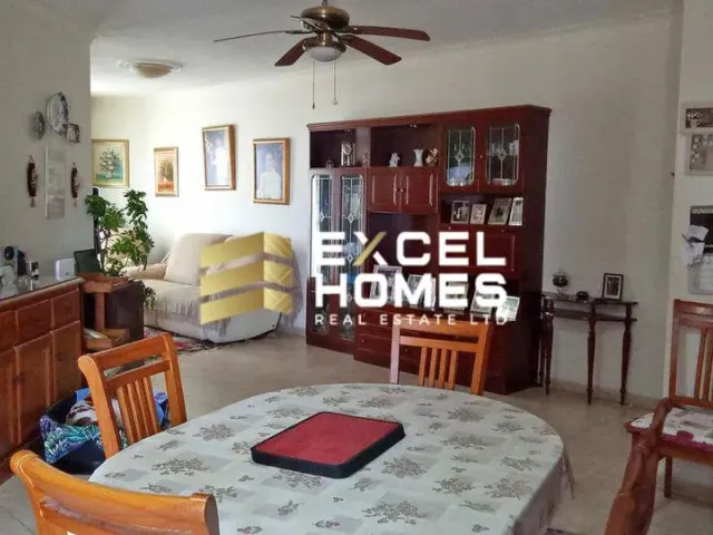 a living room with a table and chairs