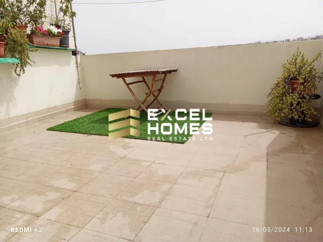 a bench sitting in front of a garden