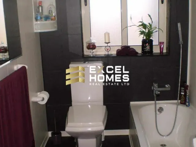 a bathroom with a toilet, sink, and mirror