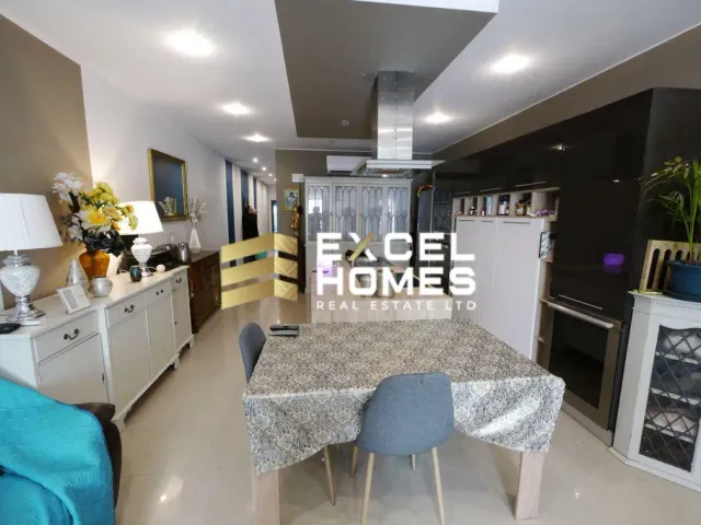 a living room with a couch, table, chairs and a tv