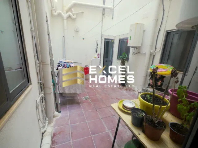 a small kitchen with a flower arrangement on the counter