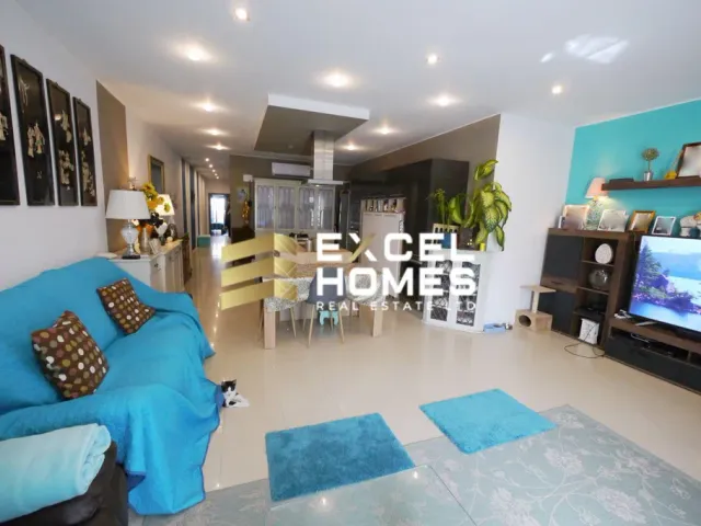 a living room with a couch, television, and a tv