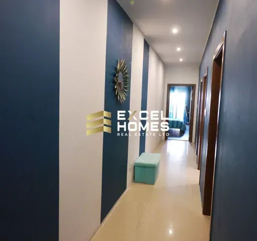 a hallway with a blue wall and a blue floor