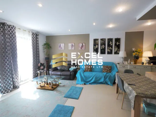 a living room with a couch, coffee table, and a bed