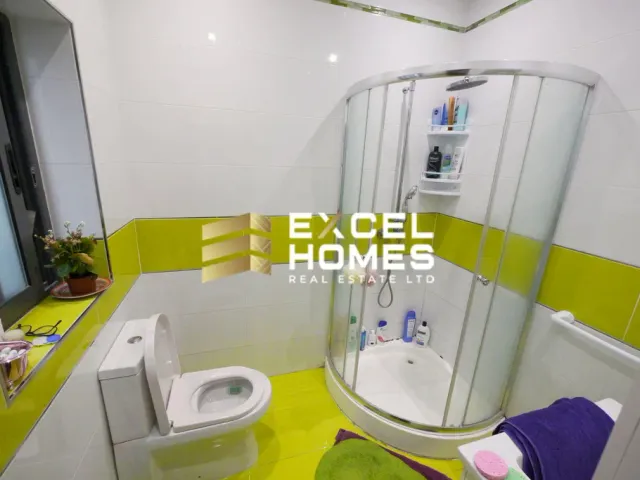 a bathroom with a toilet, sink, and shower