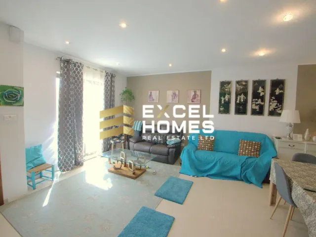 a living room with a couch, coffee table, and a television