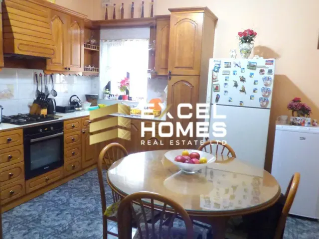 a kitchen with a stove, refrigerator, sink and a table