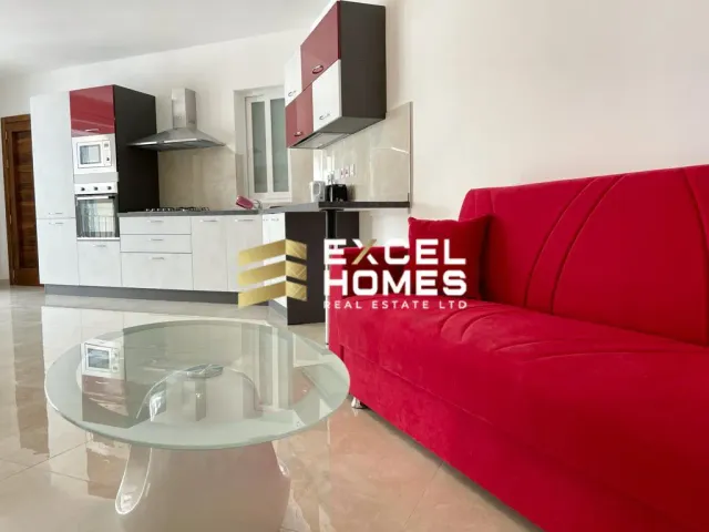 a living room with a couch, coffee table and a television