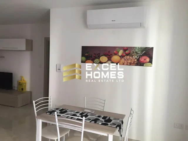 a kitchen with a table and a table cloth