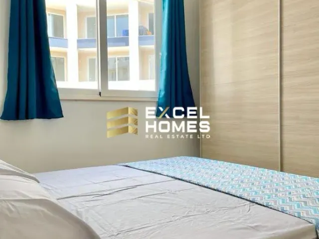 a bed with a blue blanket and a blue comforter