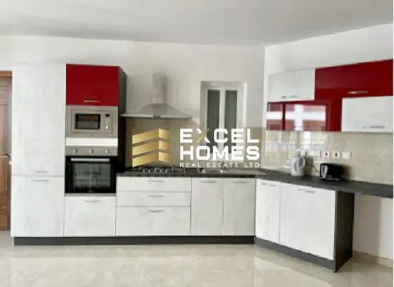 a kitchen with a white counter top and a white refrigerator