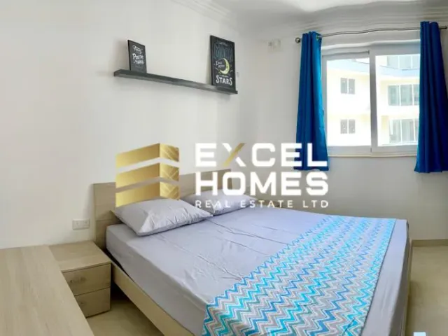 a bed with a white bedspread and a blue comforter