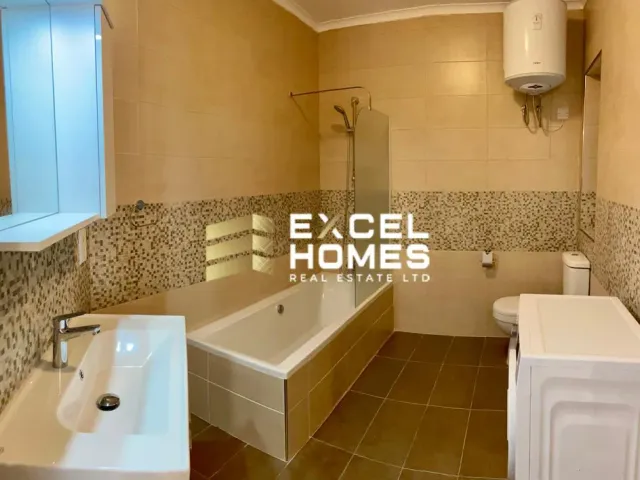 a bathroom with a sink, toilet, tub and mirror