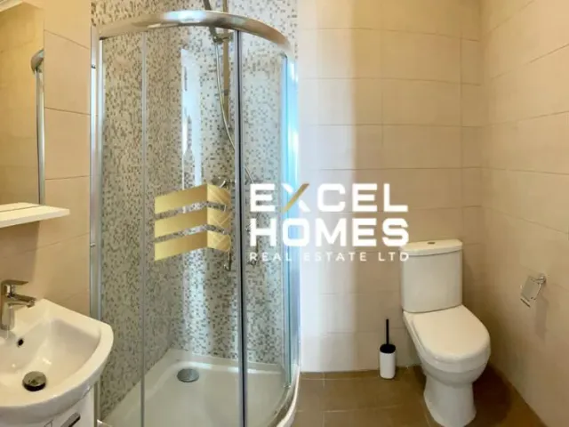 a bathroom with a toilet, shower, and sink