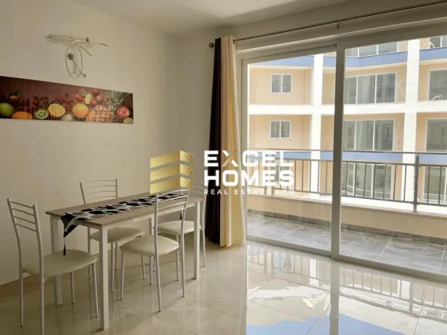 a kitchen with a table and chairs and a window