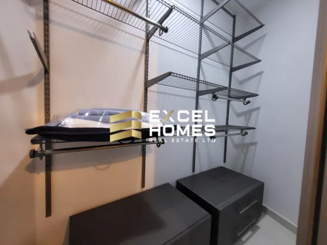 a room with a shelf with a phone and a shelf with a book