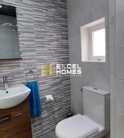 a bathroom with a sink, toilet and a mirror