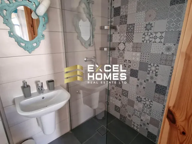 a bathroom with a sink, mirror, and toilet