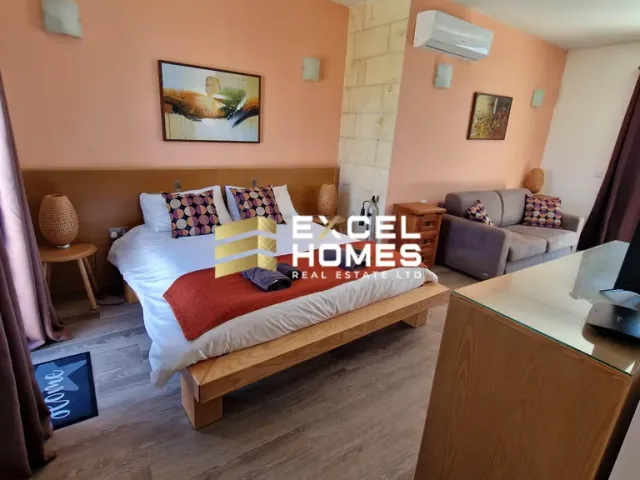 a bed room with a bed, chair, and a tv