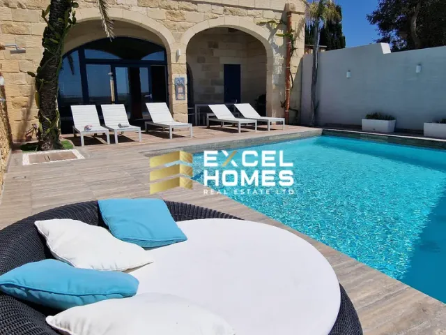 a patio with a pool table and chairs