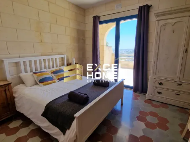 a bedroom with a bed, a window and a bedspread