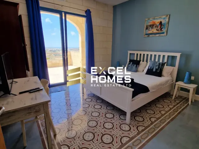 a white bed sitting in a room next to a wall