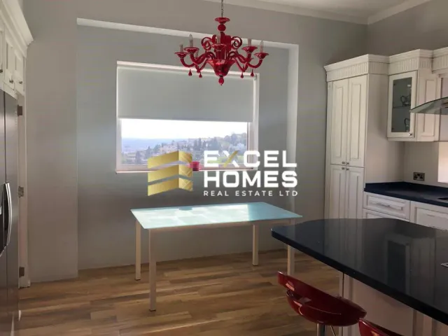 a kitchen with a table and a refrigerator