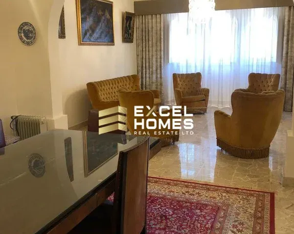 a living room with a couch, chair, table and a television